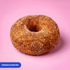 Gluten free vegan baked ring doughnut rolled in cinnamon sugar