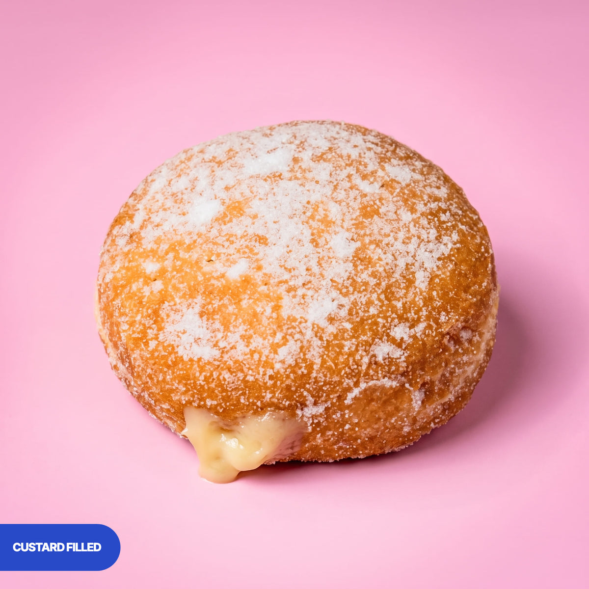 Gluten free oat free vegan fried sugared doughnut filled with vanilla custard, the filling visible at the side